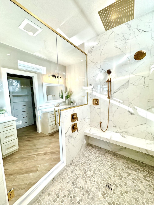 bathroom with vanity and a shower