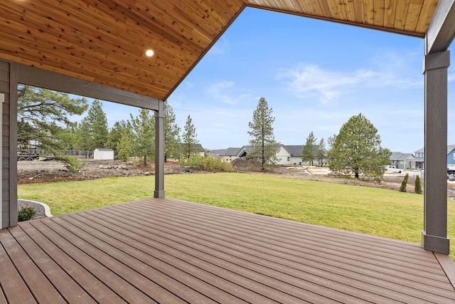 wooden terrace featuring a lawn