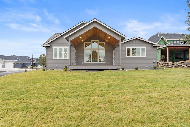 rear view of property with a lawn