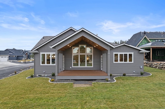 rear view of property with a yard and a deck