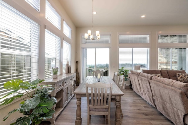 dining room featuring hardwood / wood-style floors and an inviting chandelier