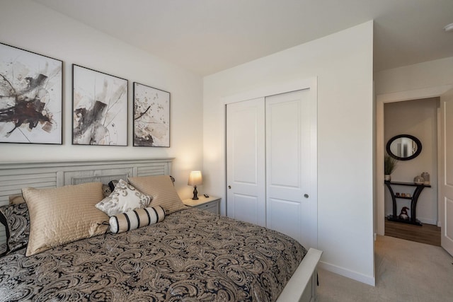 bedroom with light colored carpet and a closet