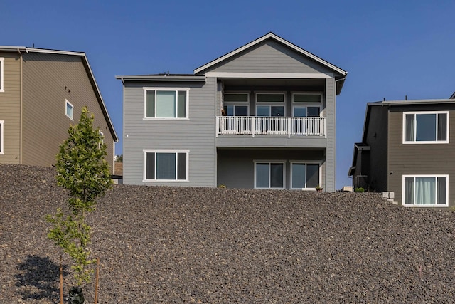 back of house featuring a balcony