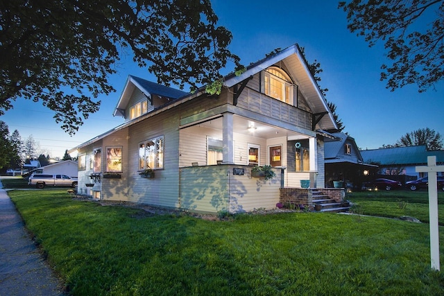 view of front of property featuring a front lawn and covered porch