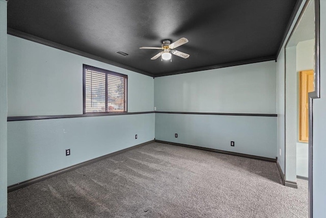 carpeted empty room with ceiling fan and ornamental molding