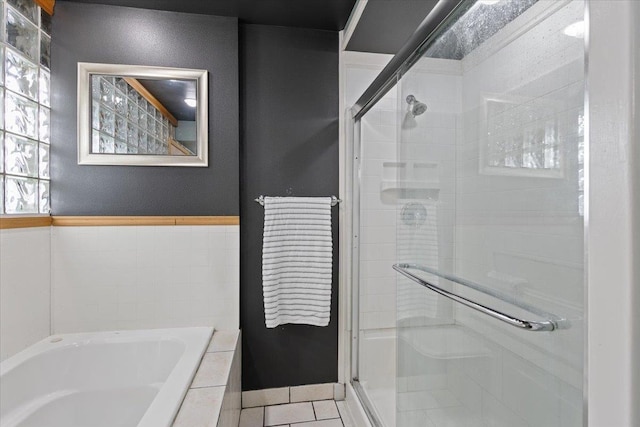 bathroom featuring tile patterned floors, plenty of natural light, and shower with separate bathtub