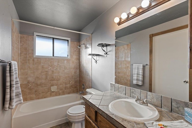 full bathroom featuring tiled shower / bath combo, toilet, and vanity