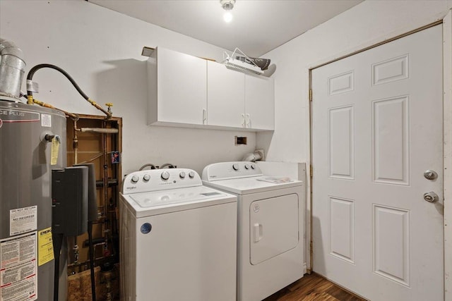 clothes washing area featuring cabinets, dark hardwood / wood-style flooring, washer and dryer, and gas water heater