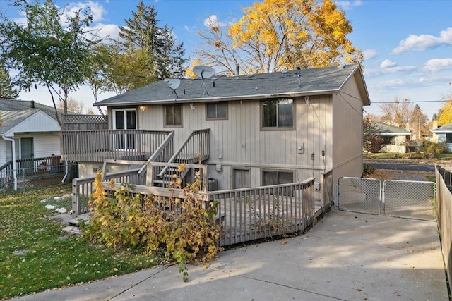 rear view of house featuring a wooden deck