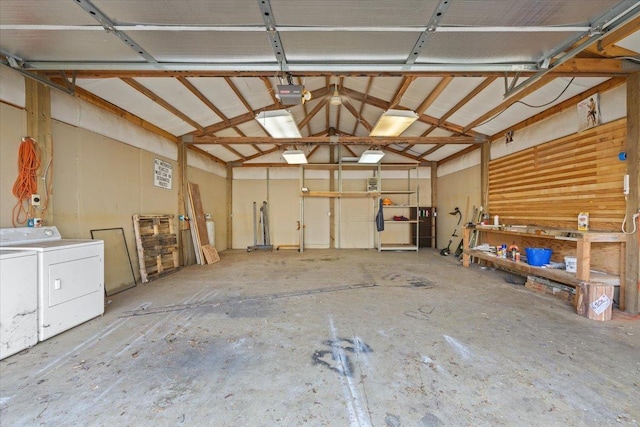 garage with washer and dryer and a garage door opener