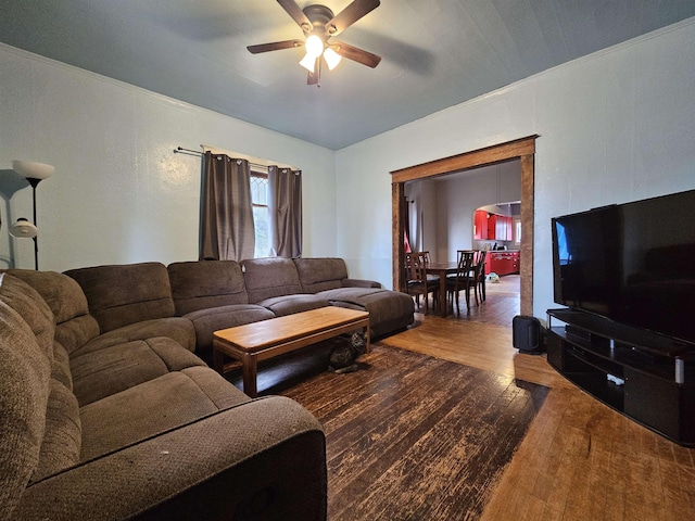 living room with ceiling fan, wood-type flooring, and crown molding