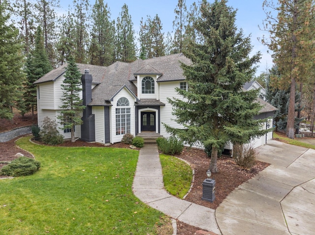 view of front of home featuring french doors and a front lawn