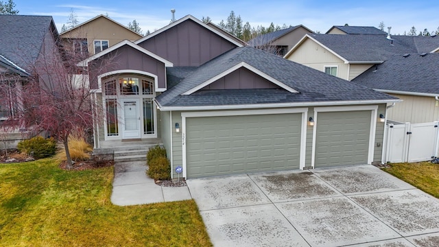 view of front of property featuring a front lawn and a garage