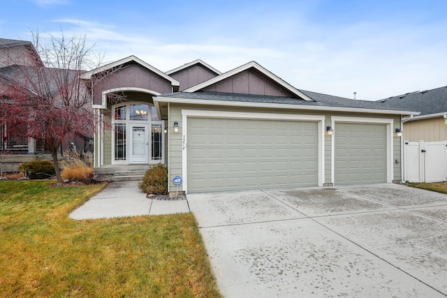 ranch-style home featuring a front yard and a garage