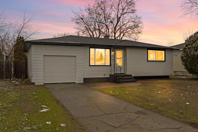 view of front of property with a yard and a garage