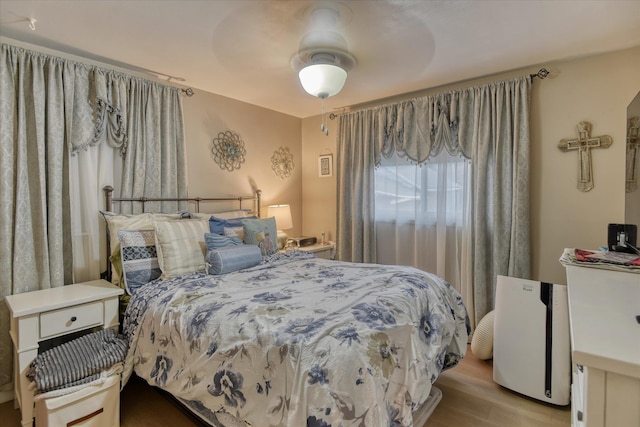 bedroom featuring ceiling fan and light hardwood / wood-style flooring