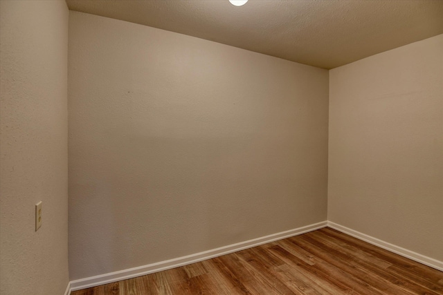 spare room with hardwood / wood-style flooring