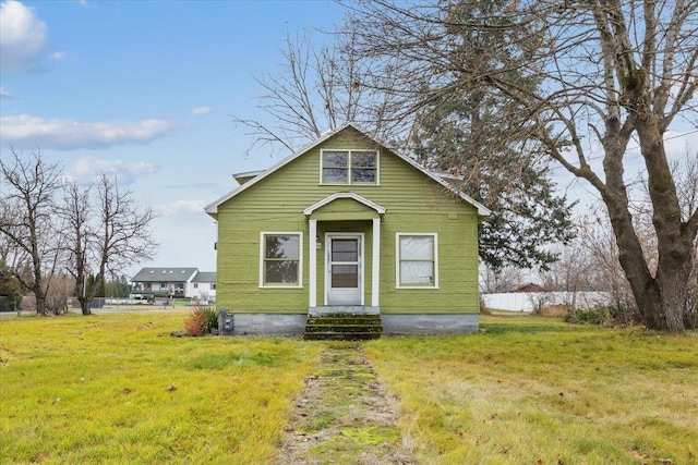 bungalow-style home with a front lawn