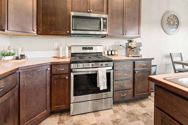 kitchen featuring dark brown cabinets and appliances with stainless steel finishes