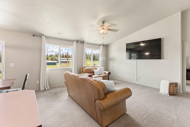 living room featuring a textured ceiling, ceiling fan, light carpet, and lofted ceiling