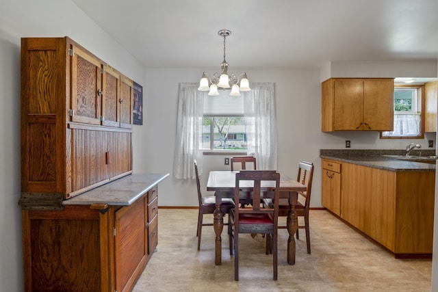 dining room featuring a chandelier, plenty of natural light, and sink