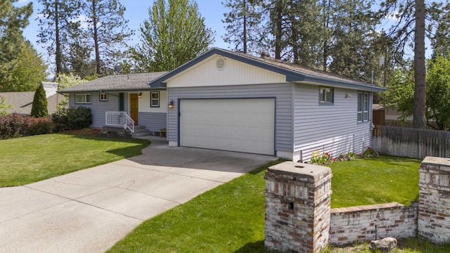 ranch-style house featuring a garage and a front lawn