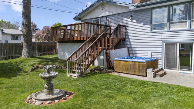 view of yard with a wooden deck and a hot tub