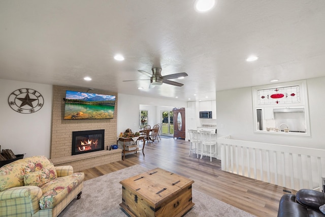 1323 E Deerhaven Ave Dalton Gardens, Dalton Gardens, Coeur D Alene, ID 83815 - living room featuring ceiling fan, wood-type flooring, and a brick fireplace