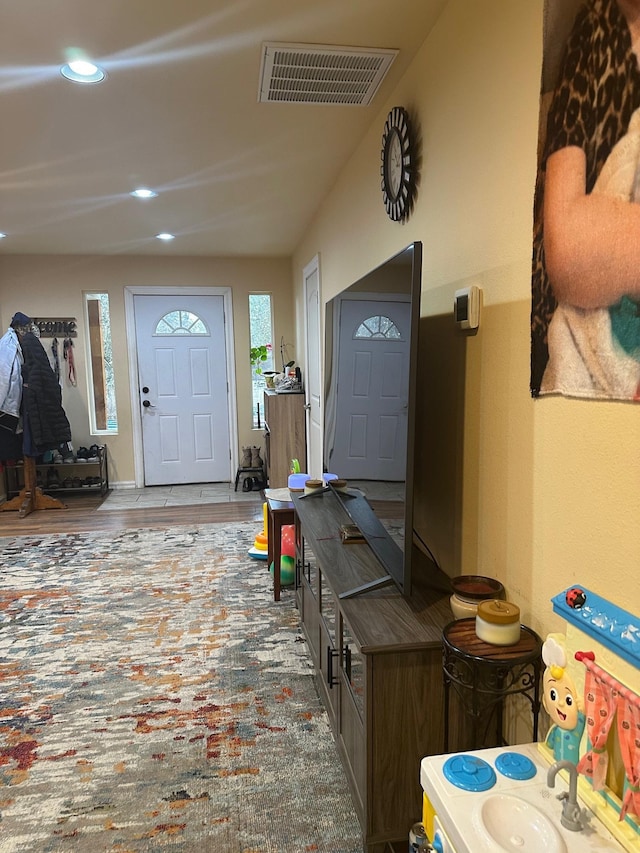 entryway with hardwood / wood-style flooring and sink