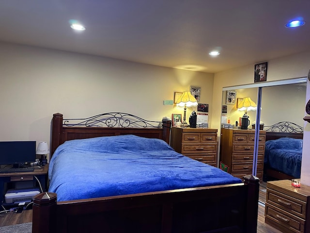 bedroom with dark hardwood / wood-style flooring