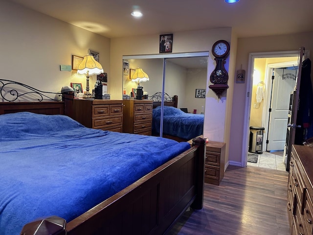 bedroom with wood-type flooring and a closet