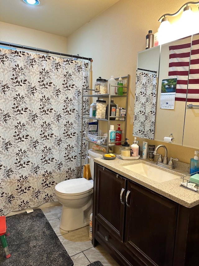 bathroom with tile patterned floors, vanity, and toilet