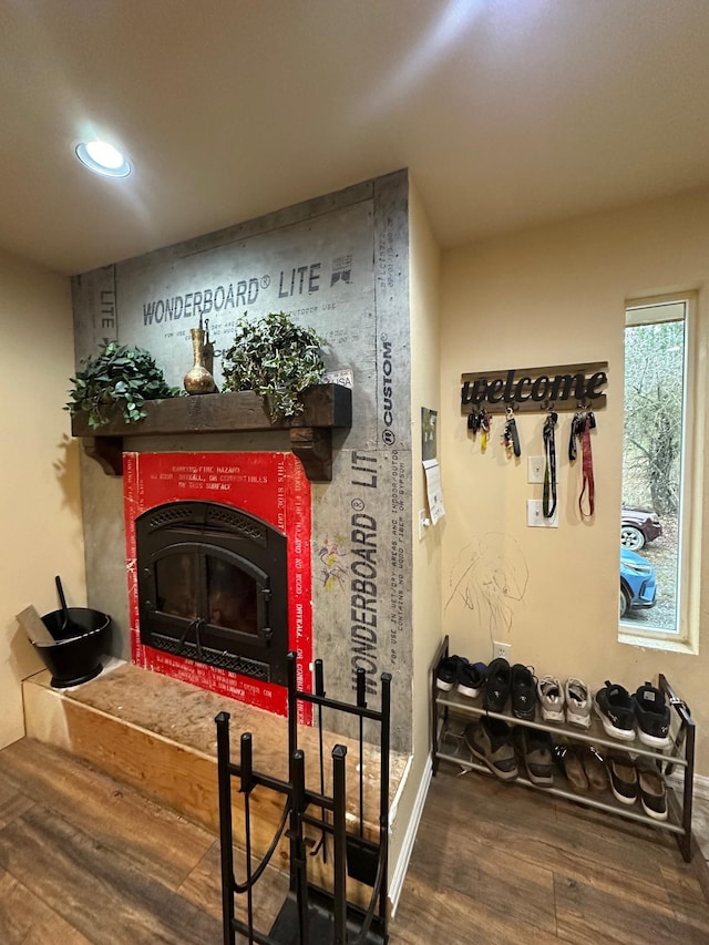 room details featuring a tiled fireplace and hardwood / wood-style floors