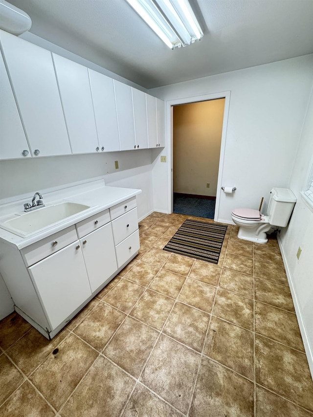 laundry room with light tile patterned floors and sink