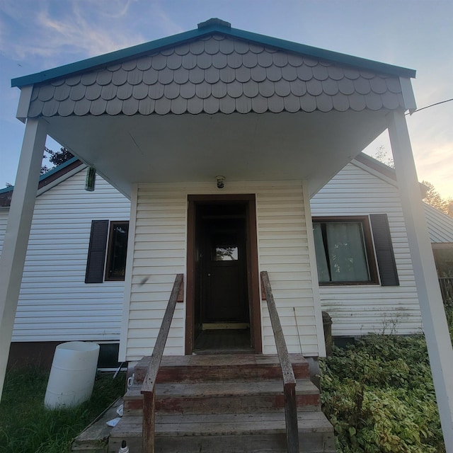 view of exterior entry at dusk