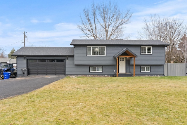 bi-level home with a front yard and a garage