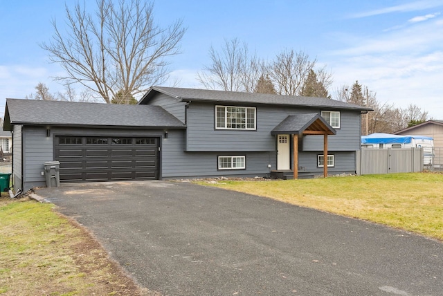 bi-level home featuring a front yard and a garage