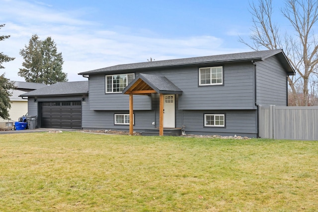 split foyer home with a garage and a front yard