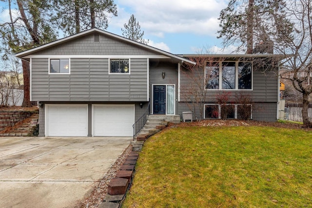 split foyer home with a front yard and a garage