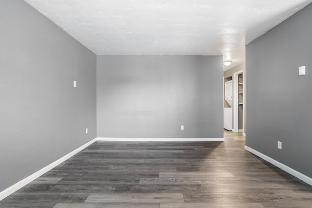 unfurnished room featuring dark hardwood / wood-style flooring