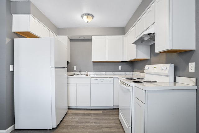 kitchen with sink, white cabinets, white appliances, and light wood-type flooring