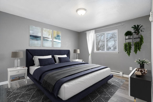 bedroom featuring hardwood / wood-style flooring and a baseboard radiator