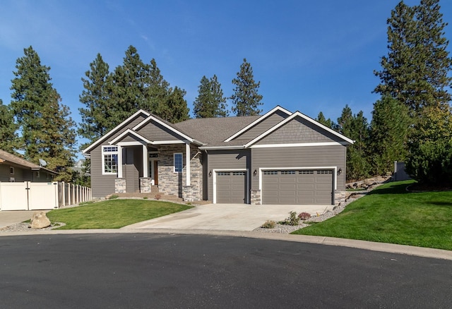 craftsman house featuring a garage and a front lawn