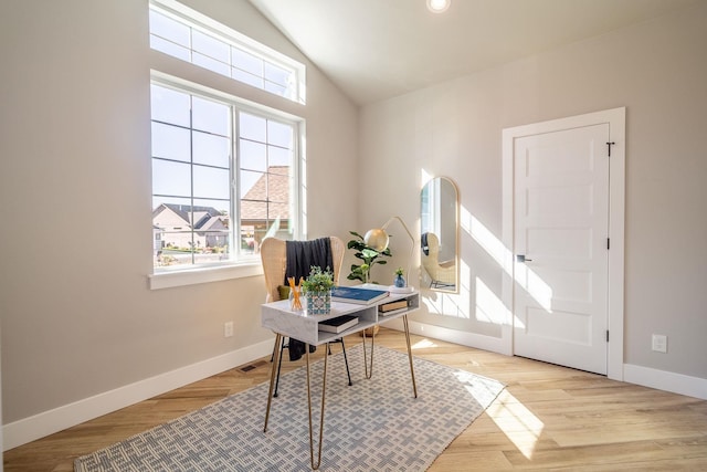 home office featuring light hardwood / wood-style flooring and lofted ceiling