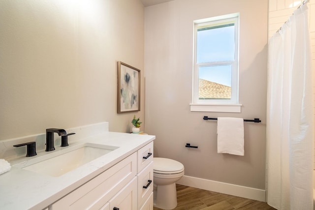 bathroom featuring hardwood / wood-style flooring, vanity, curtained shower, and toilet