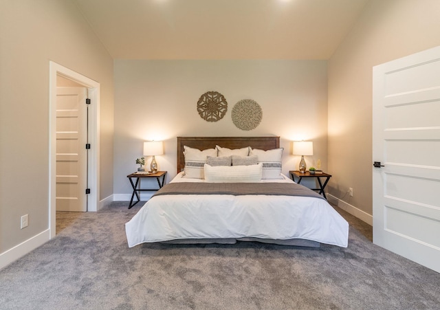 carpeted bedroom with lofted ceiling