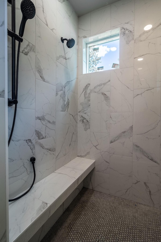 bathroom with a tile shower