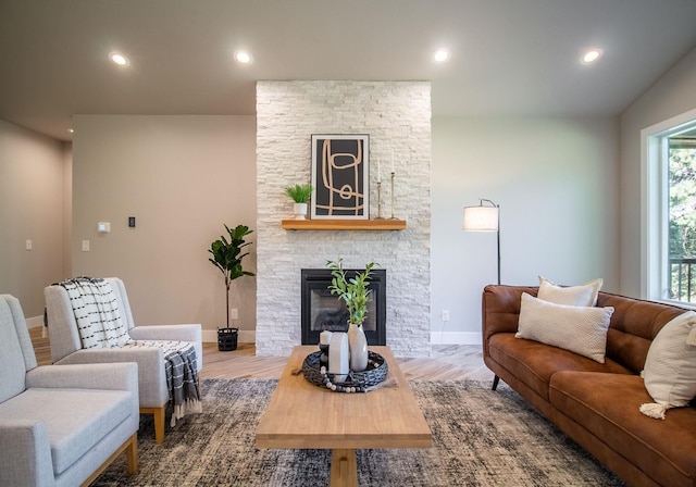 living room with plenty of natural light, wood-type flooring, and a fireplace