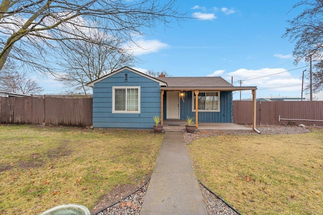 single story home featuring a porch and a front lawn