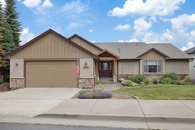 view of front of property featuring a garage and a front lawn